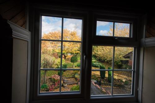 a window looking out at a garden outside at The Royal Arms Hotel in Sutton Cheney
