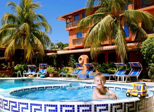 a baby in a swimming pool at a hotel at Hotel Costa Linda Beach in La Loma