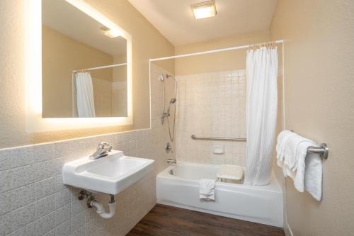a bathroom with a sink and a toilet and a shower at SureStay Hotel by Best Western Fairfield Napa Valley in Fairfield