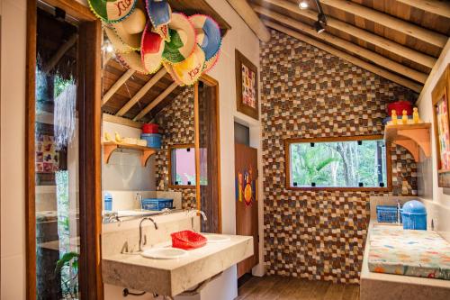 a bathroom with a sink and a mirror at Itacaré Eco Resort in Itacaré