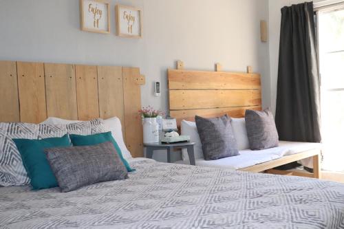 a bedroom with a large bed and a bench at Habitaciones Samy in San Francisco
