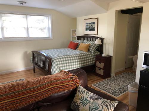a bedroom with a bed and a couch in a room at 14 Charles St Apartment in Guilford
