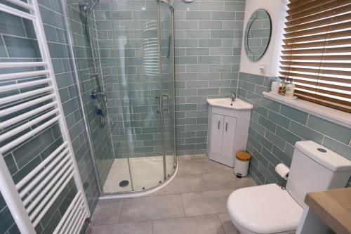 a bathroom with a shower and a toilet at Tweedbank in Galashiels