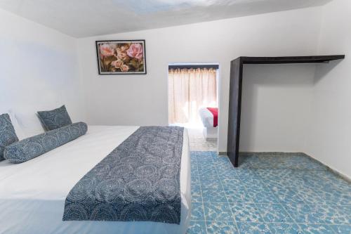 a hotel room with a bed and a window at Donjuan By Melida Hotel in Cabo San Lucas