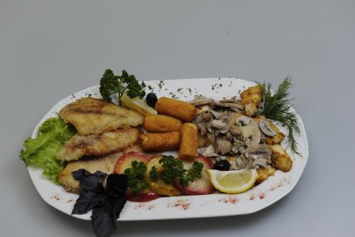 a plate of food with seafood and vegetables on it at Fontan in Chornomorsk