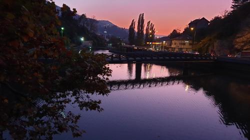 a bridge over a river at sunset at Pansion River in Sarajevo