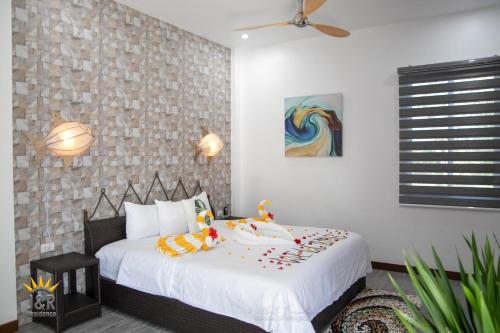a bedroom with a large white bed in a room at J&R Residence in Anda
