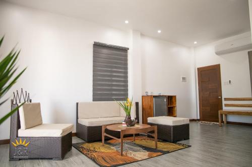 a living room with two chairs and a table at J&R Residence in Anda