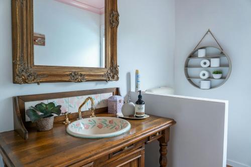 a bathroom vanity with a sink and a mirror at Wyndover Mountain Retreat in Beechmont