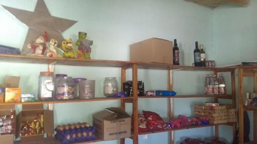 a room with shelves with bottles and other items at Camping agreste El Algarrobo de Quilmes in Amaicha del Valle