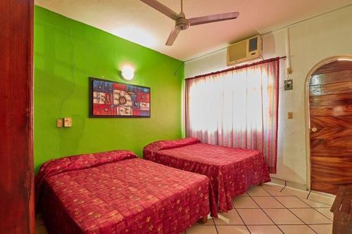 A bed or beds in a room at Hotel Posada San Rafael