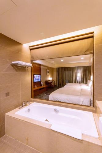 Ένα ή περισσότερα κρεβάτια σε δωμάτιο στο Fullon Hotel Tamsui Fishermen's Wharf