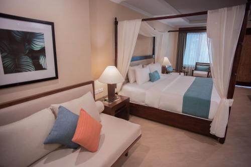 a hotel room with two beds and a television at Boracay Mandarin Island Hotel in Boracay