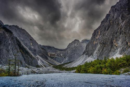 a view of a valley in a mountain range at The Rock Hotel in Lijiang