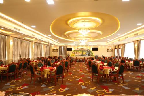 a banquet hall with tables and chairs in a hotel at Kabul Star Hotel & Restaurant in Shīrpūr