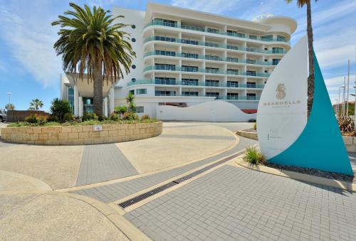a surfboard sculpture in front of a hotel at Sea Side 110 in Mandurah