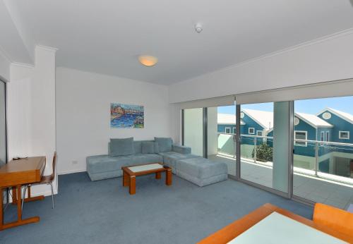 a living room with a couch and a table at Sea Side 110 in Mandurah