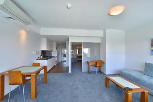 a living room with a couch and a table at Sea Side 110 in Mandurah
