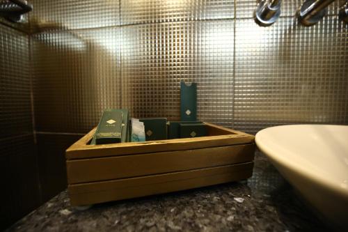 a bathroom with a wooden box with soap in it at Bahria Grand Hotel & Resort in Lahore