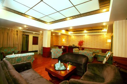 a lobby with couches and a table in a room at Regenta Orko's Haridwar, Motichur, 10 min from Har ki Pauri in Haridwār
