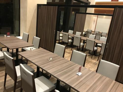 a dining room with wooden tables and chairs at International Garden Hotel Narita in Narita
