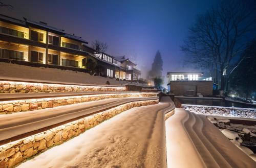 a snow covered sidewalk with buildings in the background at Evergreen Retreat-walk to National Forest Park, free pick up service in Zhangjiajie