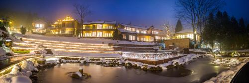 a large house with snow on the ground at Evergreen Retreat-walk to National Forest Park, free pick up service in Zhangjiajie