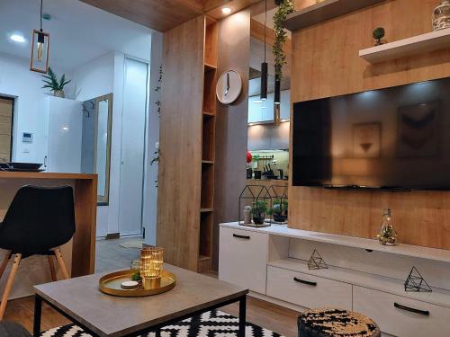 a living room with a large television and a table at Apartment A5 Lux in Jahorina