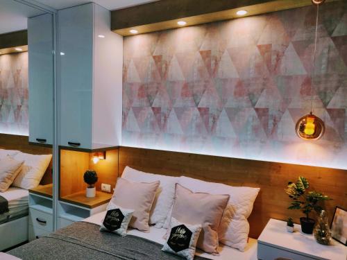 a bedroom with two beds and a mirrored wall at Apartment A5 Lux in Jahorina