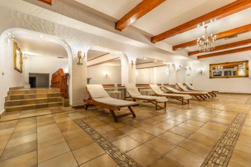 a row of chairs in a large room with stairs at Hotel Imparatul Romanilor Hotel & SPA in Sibiu
