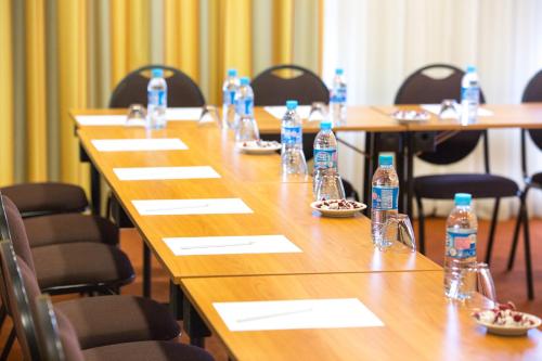 a group of tables with bottles of water on them at Hôtel Spa Du Béryl in Bagnoles de l'Orne