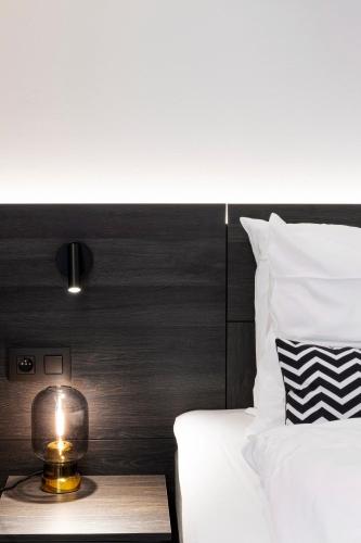 a bedroom with a bed with a candle on a table at Corsendonk Turnova in Turnhout