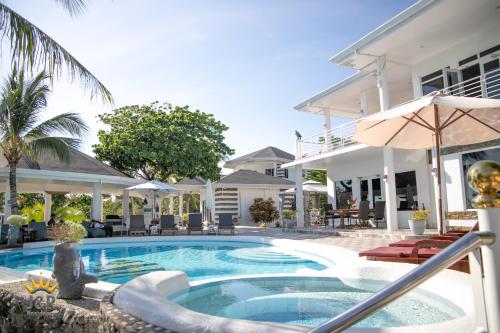 a swimming pool in front of a house at J&R Residence in Anda