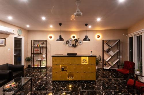 a living room with a yellow cabinet in the middle at The G Snoozebox in Udaipur