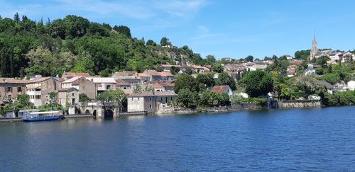 a town sitting on the side of a river at Le 72 Watt in Fumel