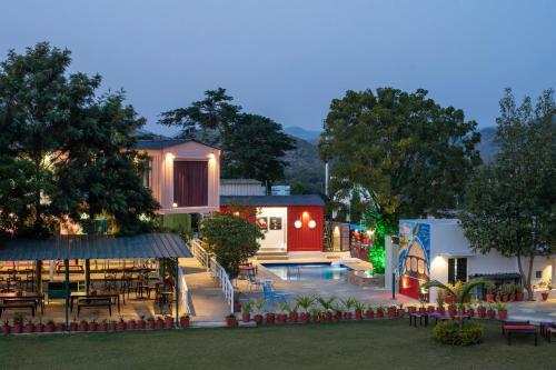 a resort with a swimming pool and a restaurant at The G Snoozebox in Udaipur