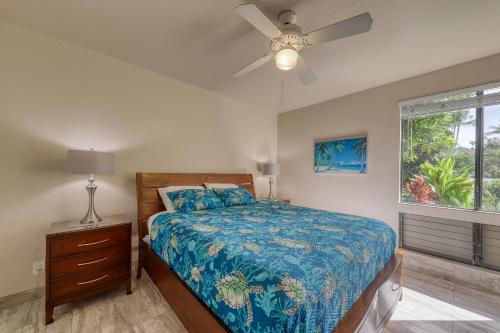 a bedroom with a bed and a ceiling fan at Wailea Grand Champions in Wailea