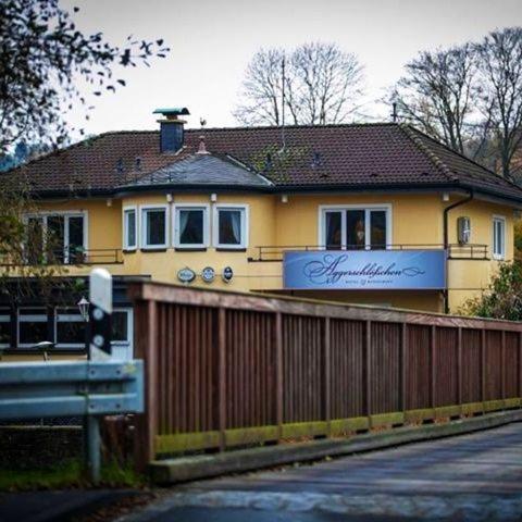 a yellow house with a fence in front of it at Aggerschlösschen in Wahlscheid