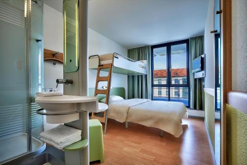 ein Krankenhauszimmer mit einem Etagenbett und einem Waschbecken in der Unterkunft ibis budget Dresden City in Dresden