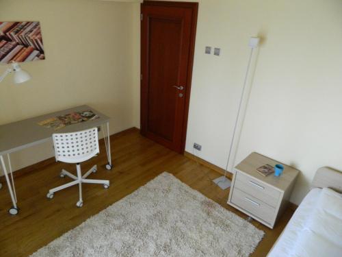 a room with a desk and a chair and a door at Anna Apartment Timișoara in Timişoara