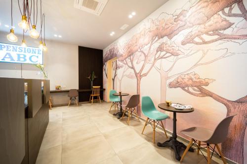 a waiting room with a mural of trees on the wall at Hotel Abc in Cervia