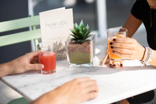 a group of people sitting at a table with drinks at Hotel Abc in Cervia
