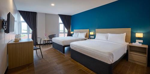 מיטה או מיטות בחדר ב-ZONE Hotels, Telok Panglima Garang