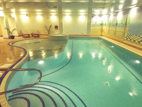 a large swimming pool in a hotel room at The Riverside in Kendal