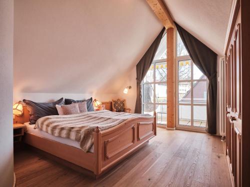 1 dormitorio con cama y ventana grande en Villa Sunside Appartements und Ferienwohnungen Schluchsee en Schluchsee