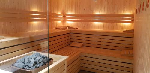 a sauna with wooden walls and wooden floors and a tub at Bilderberg Parkhotel Rotterdam in Rotterdam