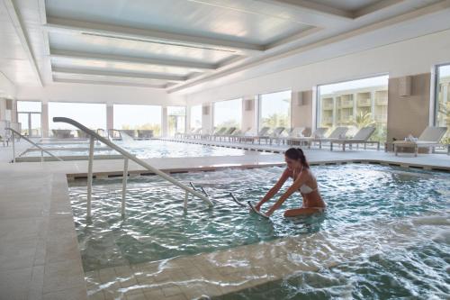 a woman is in a swimming pool at Royal Thalassa Monastir in Monastir