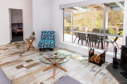 a living room with a glass table and chairs at Warburton Digs in Warburton