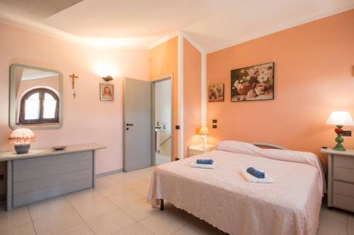 a bedroom with a bed and a sink and a mirror at ALTIDO Villa for 4 with Garden close to Pisa in Massarosa