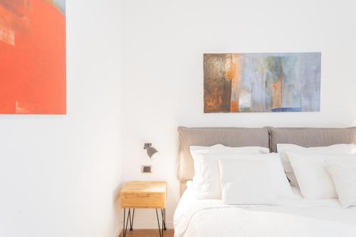 una camera da letto con un letto e un dipinto sul muro di RosArt House by Rent All Como a Como